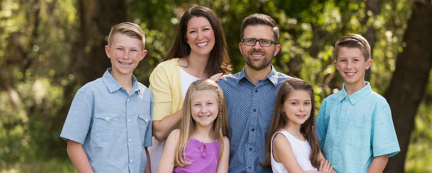 John smiling with his family