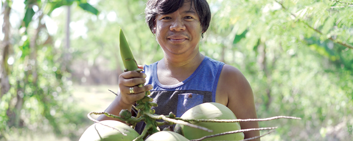 Man holding coconut branch