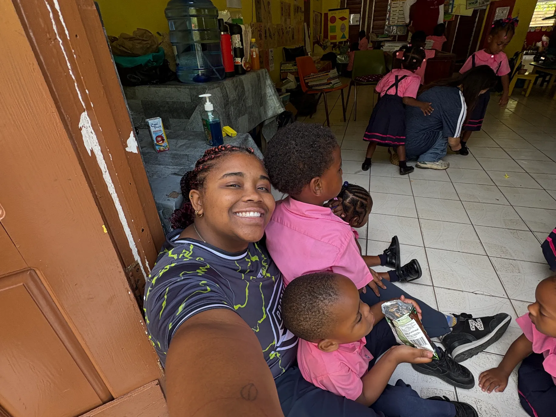Cayla Mathias ’27 with kids seated in lap.