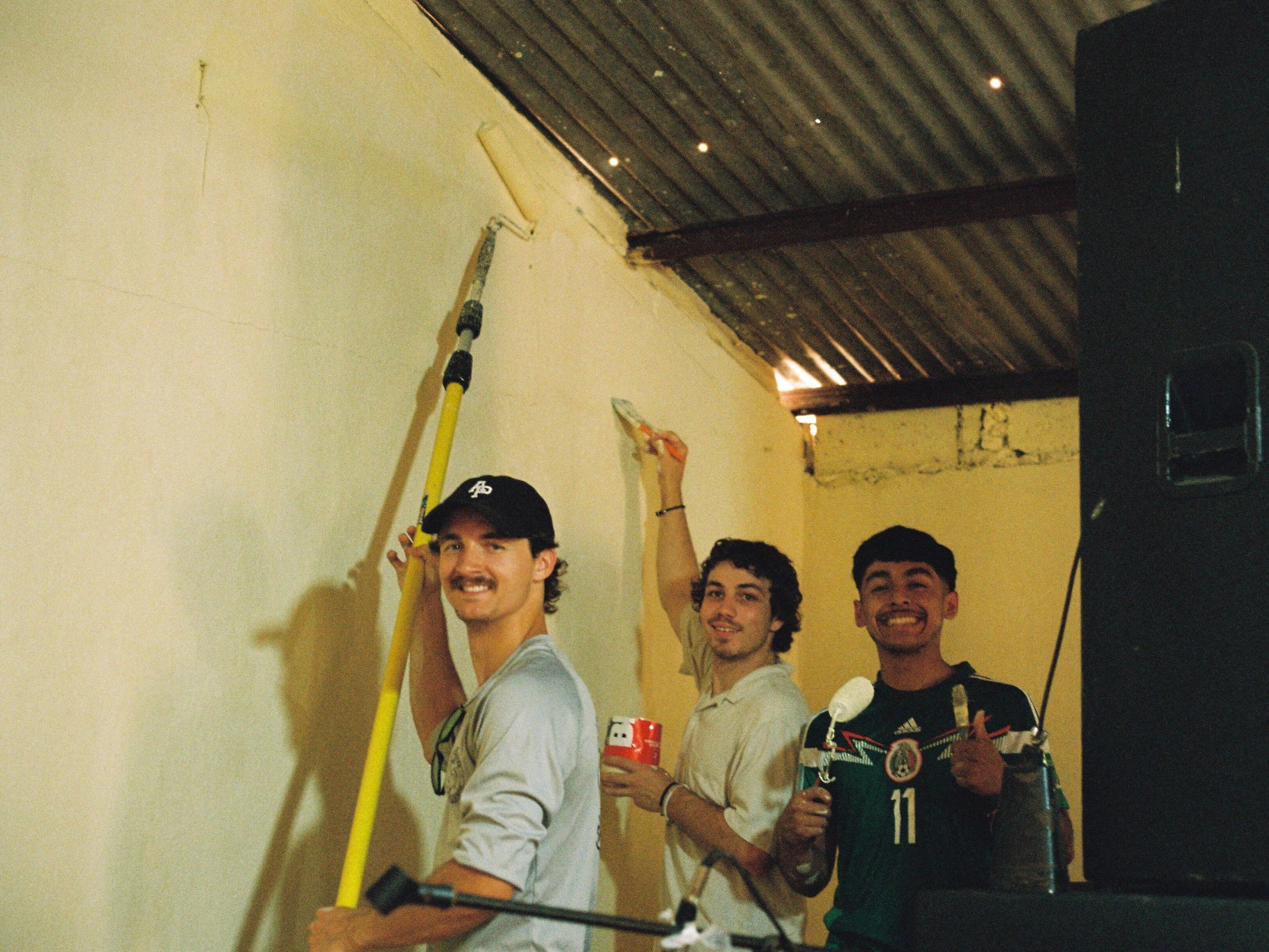 Luca Fenalson paints an orphanage wall