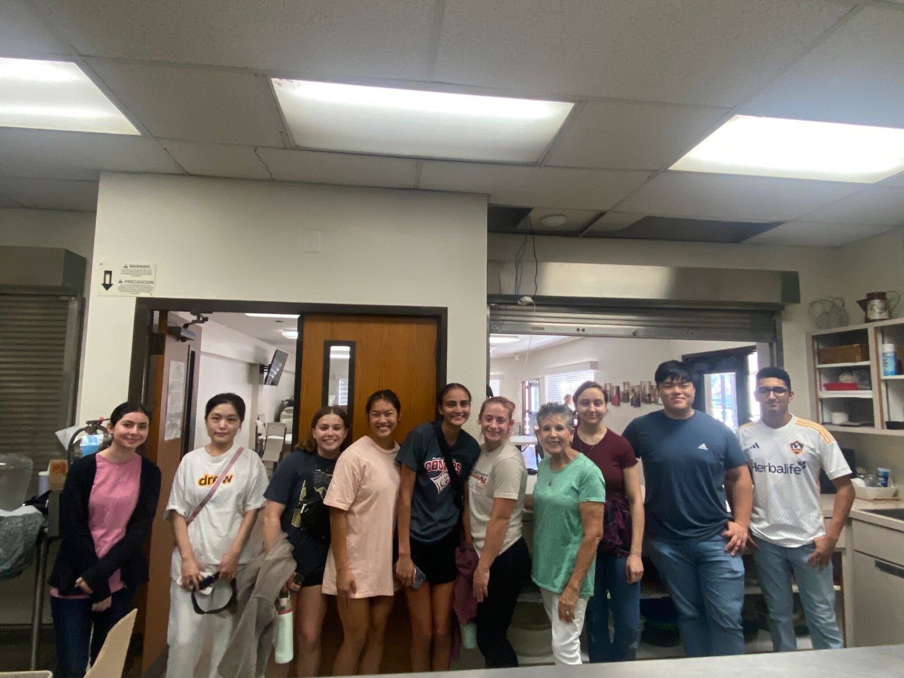 Volunteers standing for a picture in the kitchen.