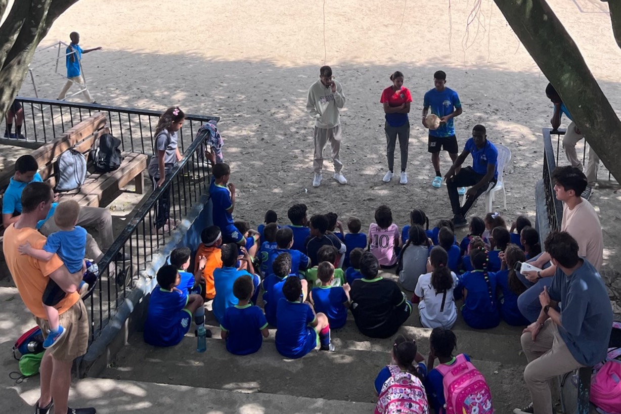 children outside in dominican republic with team