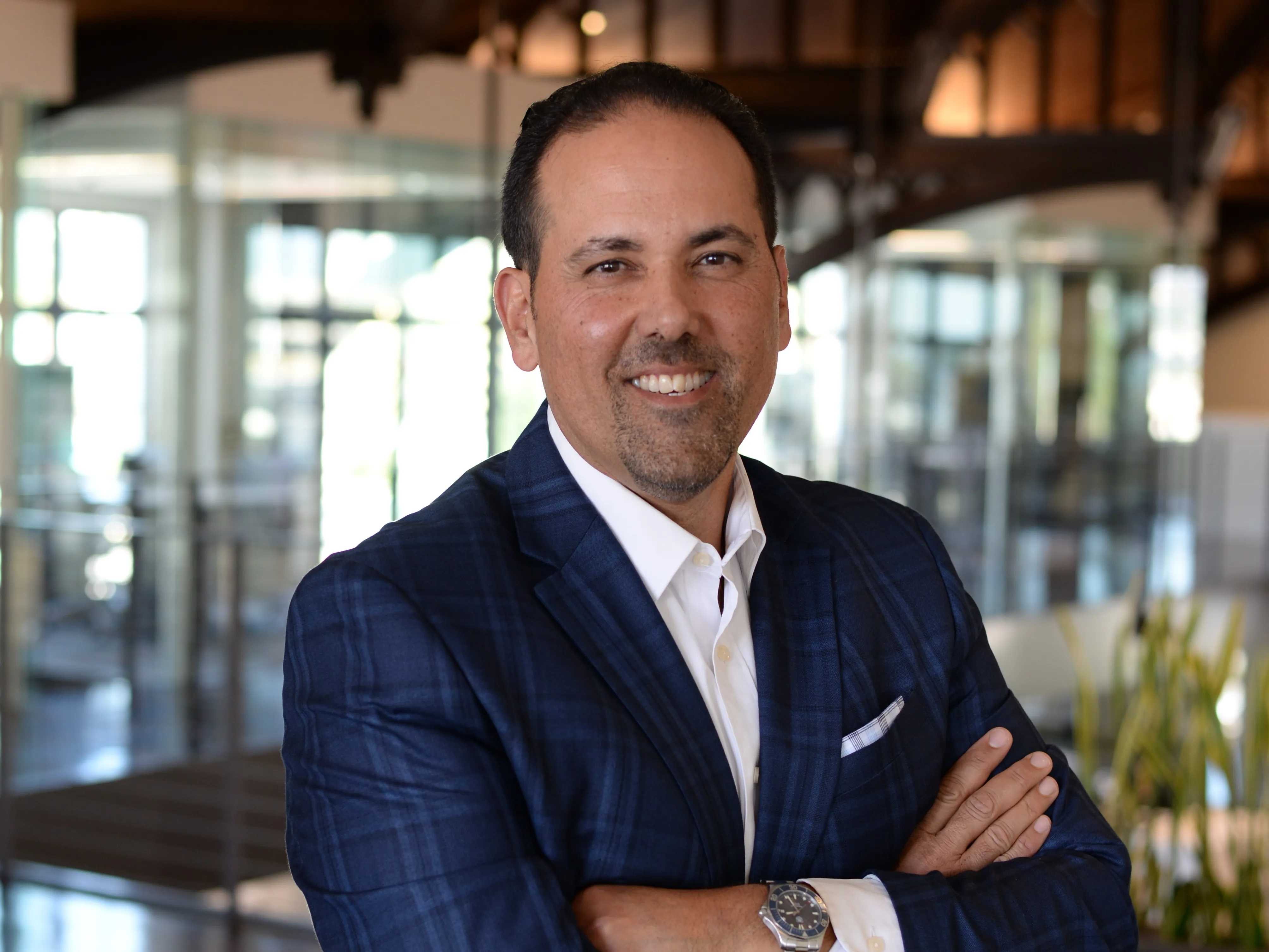Greg Nassir smiles in the CBRE office.