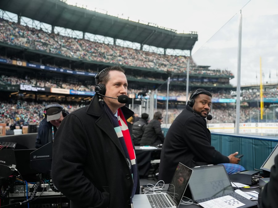 Mike Benton broadcasts rinkside at a Seattle Kraken game