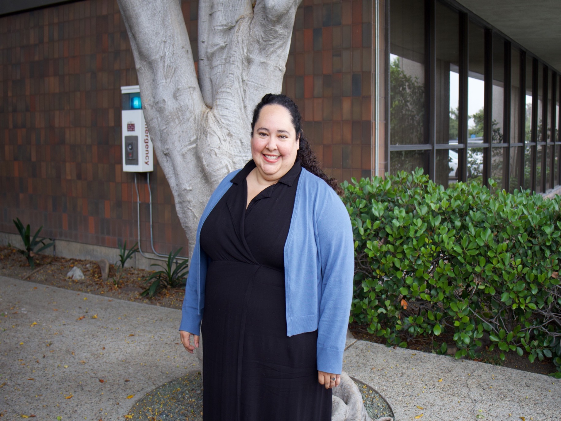 Sarah hernandez smiles outside her office