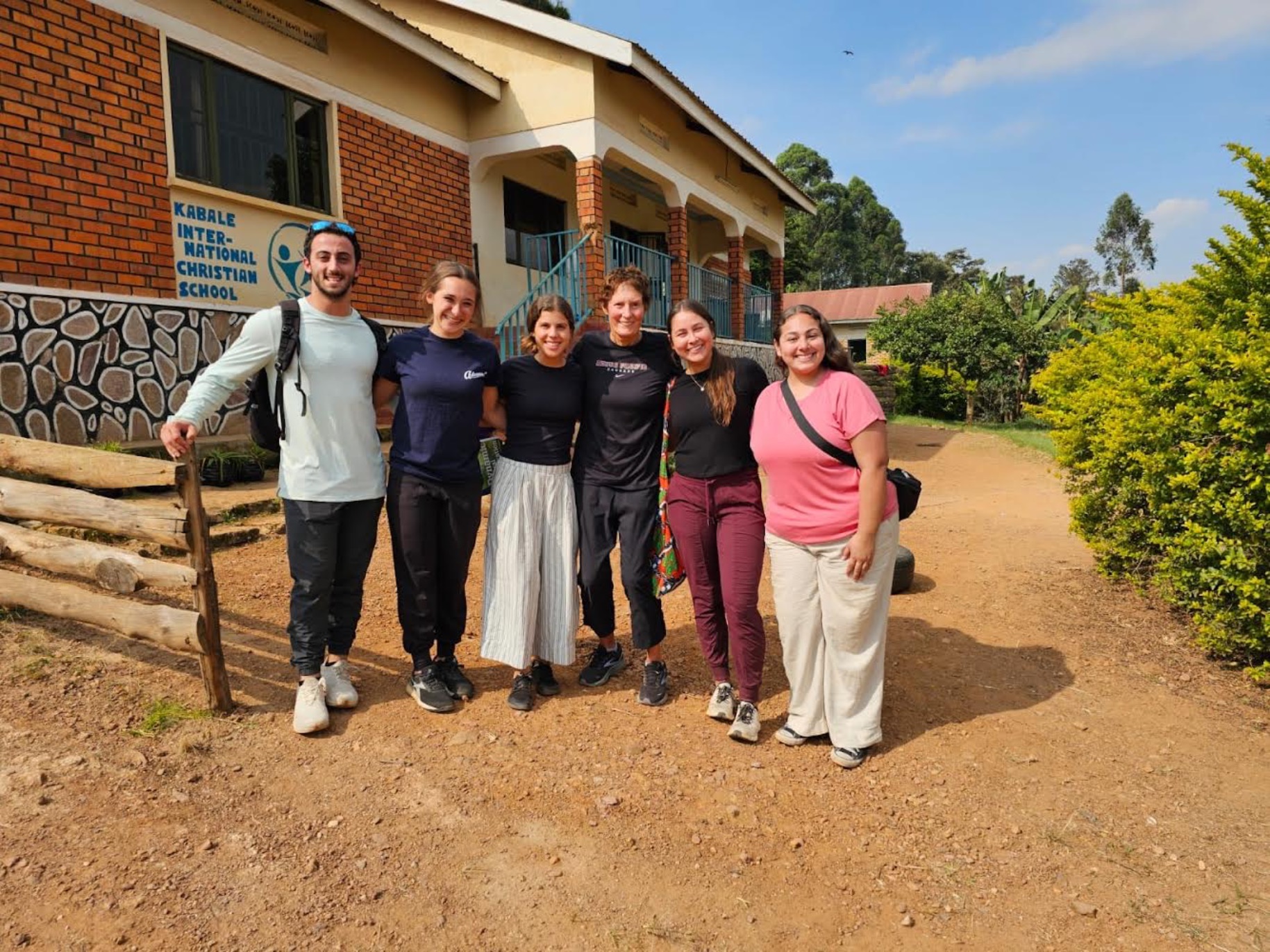 The Uganda Global Engagement team poses in front of a school they served at.