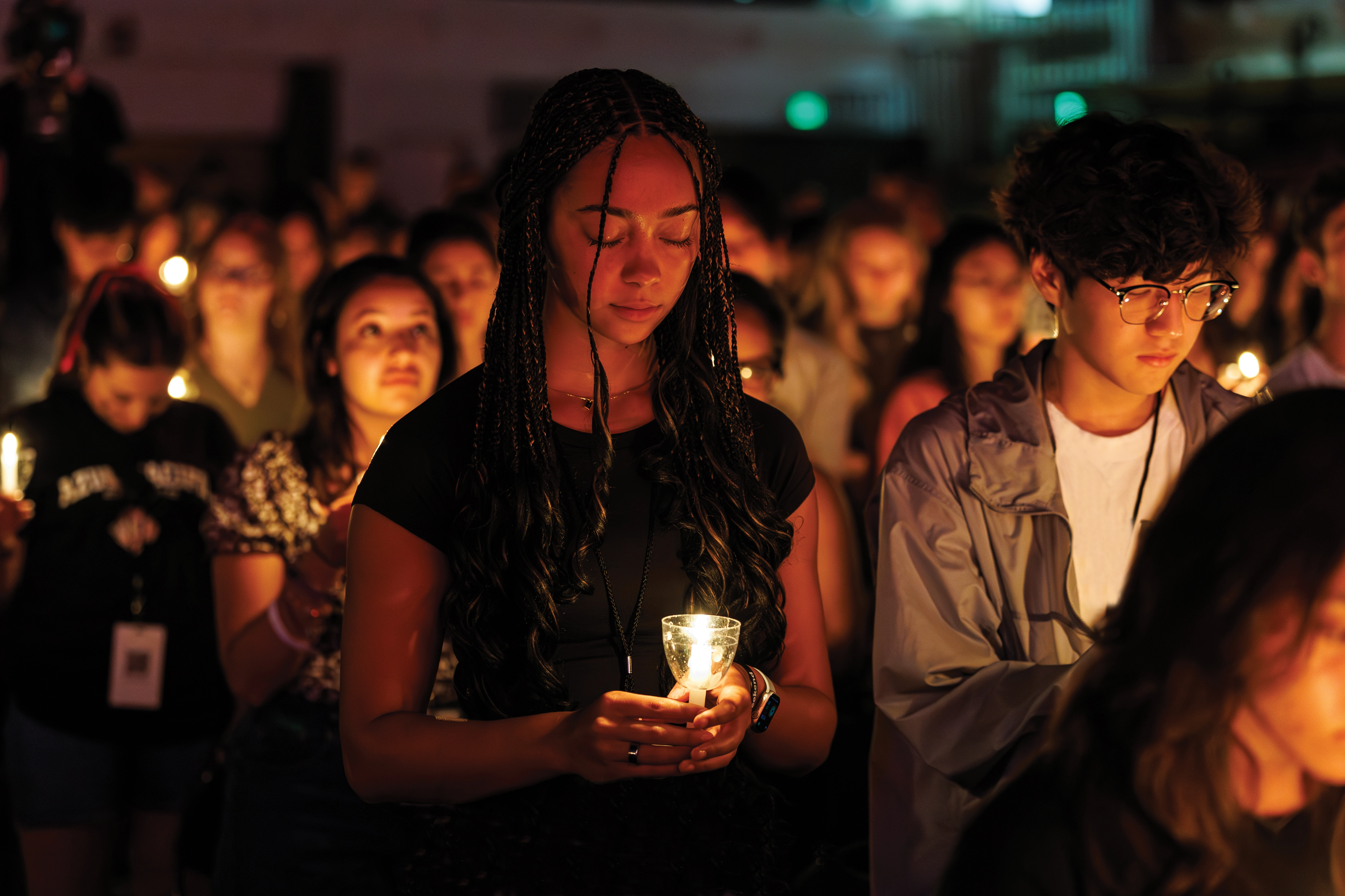 Student holding candle during Candela event
