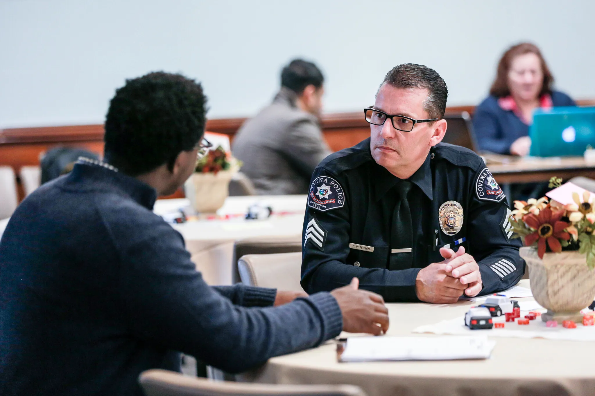 student talking to police man during class