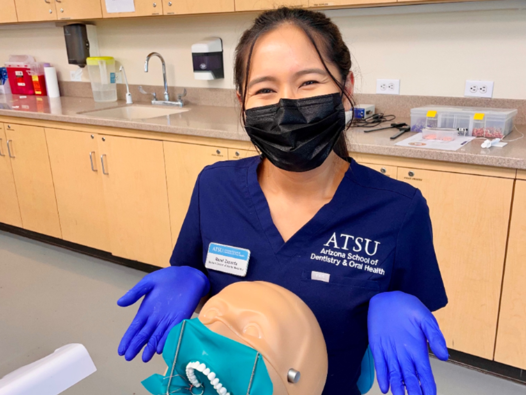 razel in scrubs with dental equipment