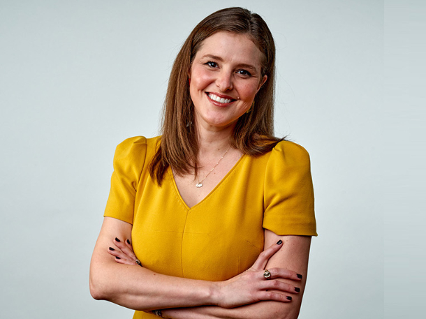 Corrie Loeffler headshot wearing yellow