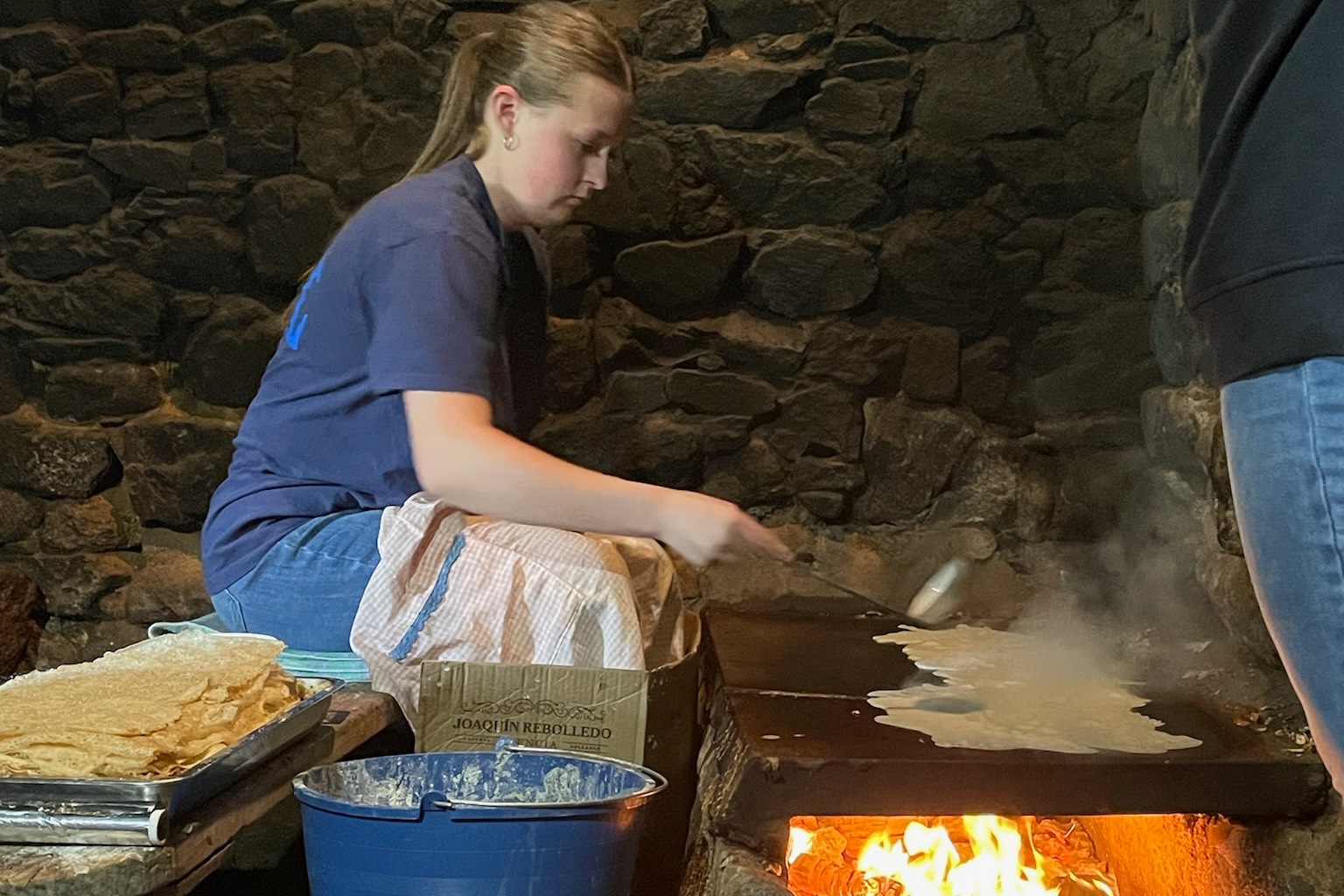 team member helping farmer cook