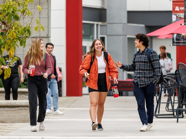 students walking and smiling on campus