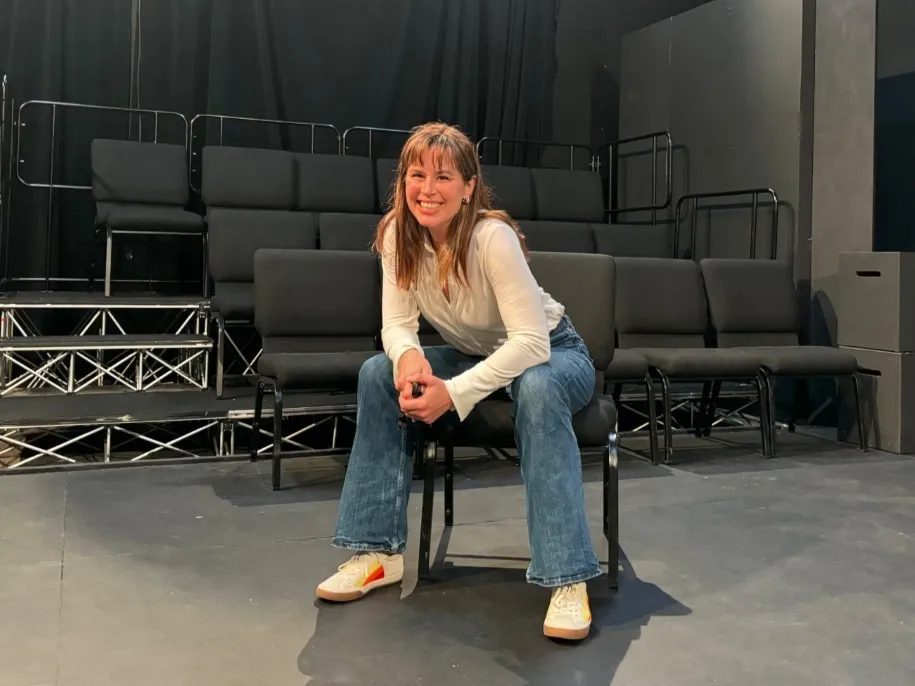 kirsten smiles while sitting backstage in apu's blackbox theater