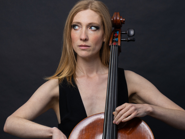 Karen Hall wearing black dress and playing the violone