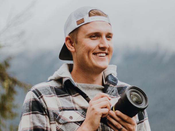 Luke Irving smiling and holding his camera