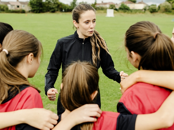 a coach giving instructions to her athletes