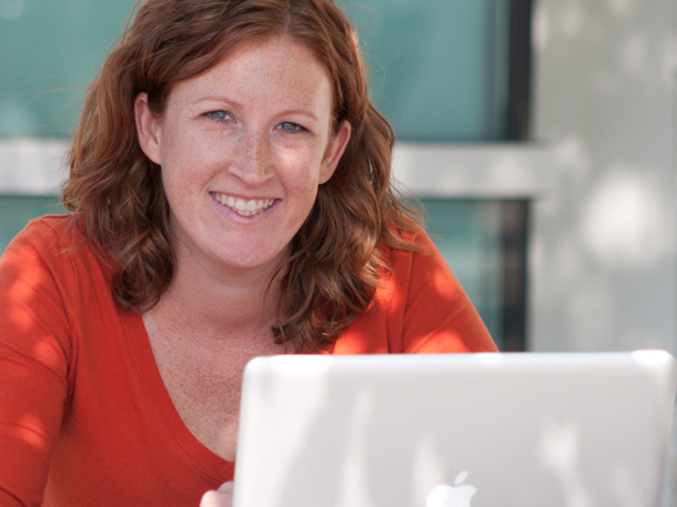 student using her laptop and smiling