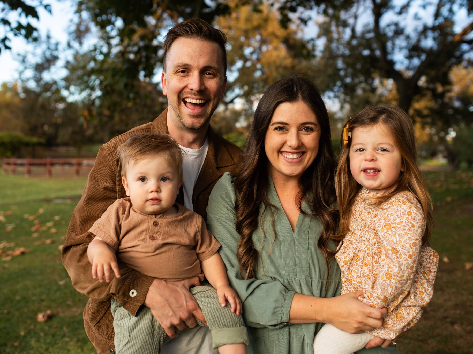 nicky smiling with his wife and 2 kids.