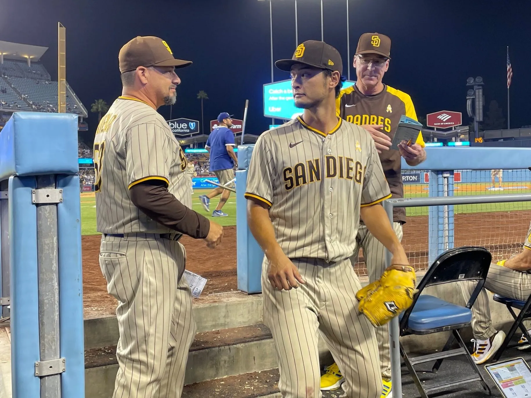 Rubens coaching a padre's baseball player during a match