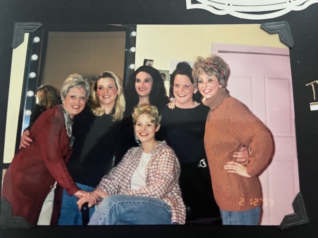 Aged photo of women standing smiling