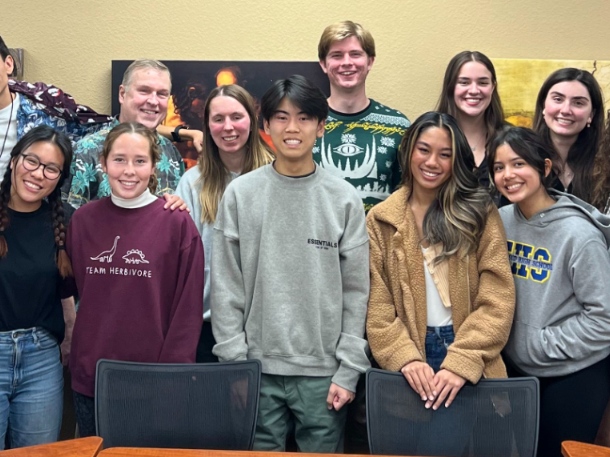 students in a classroom smiling for the picture