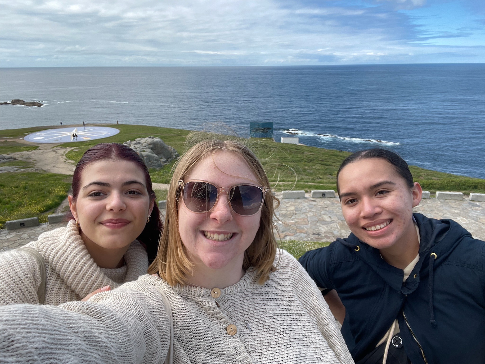 heather and her team taking a selfie by the water in Spain