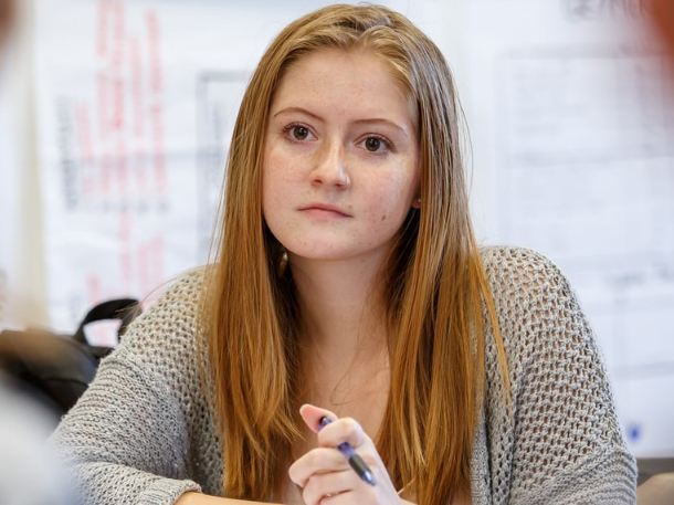 student listening to professor during class