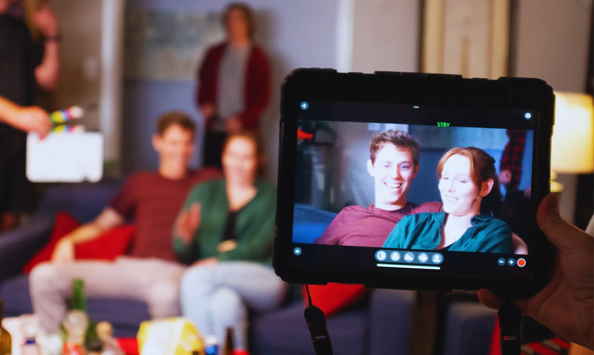 students acting during a class activity and being recorded with a camera