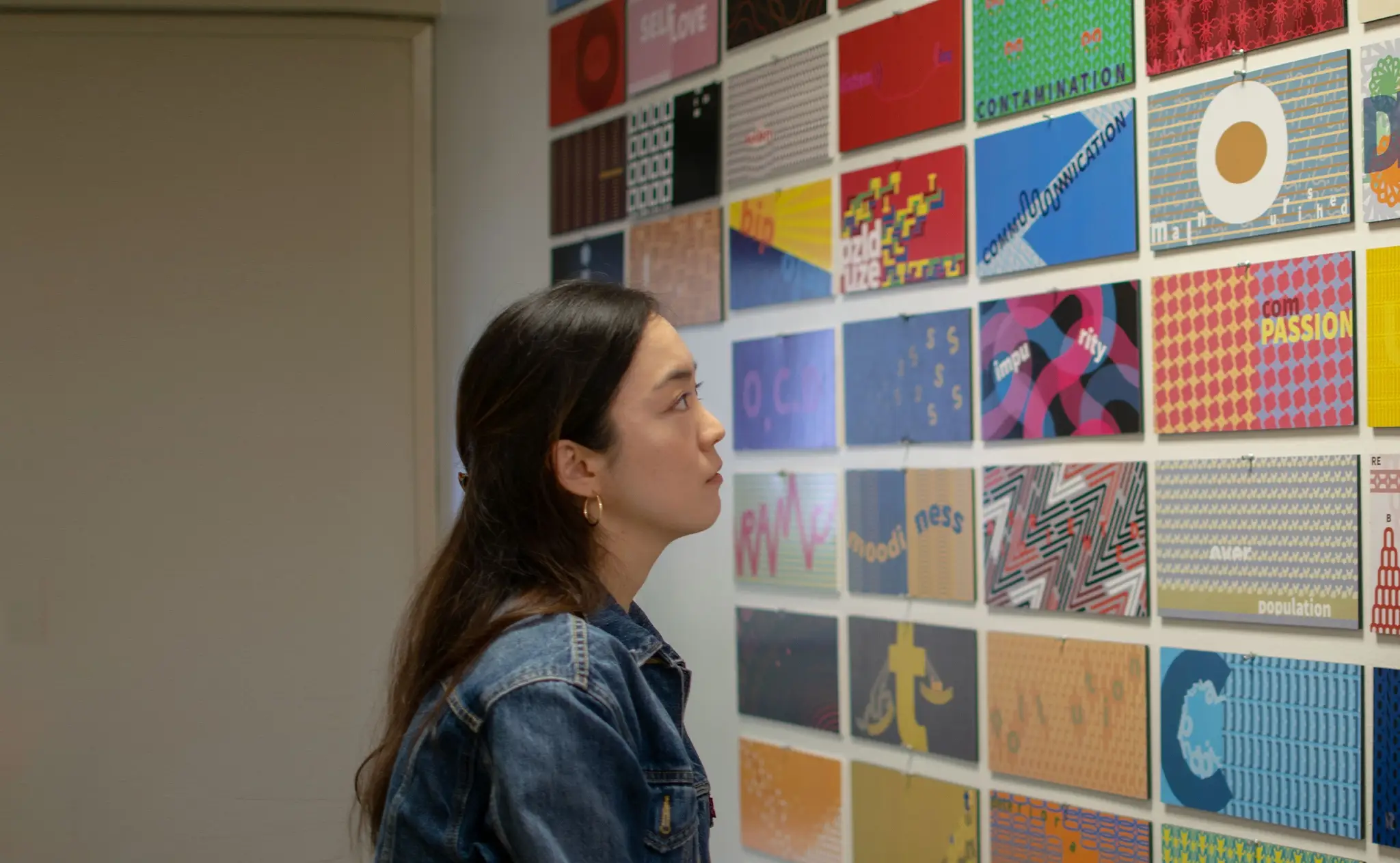 student looking at design elements on the wall