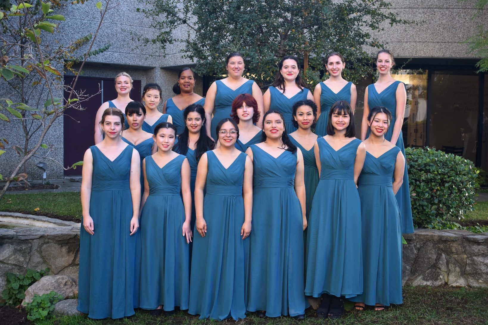 Image of choral's members wearing black clothes and singing for the choral.