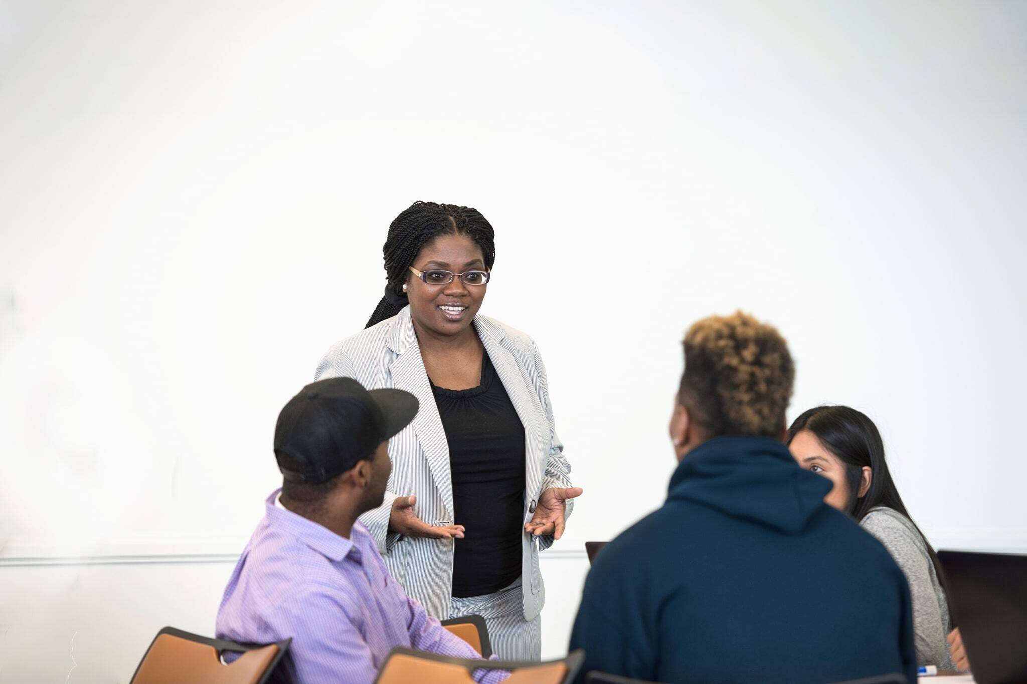 Female teacher in class speaking to students