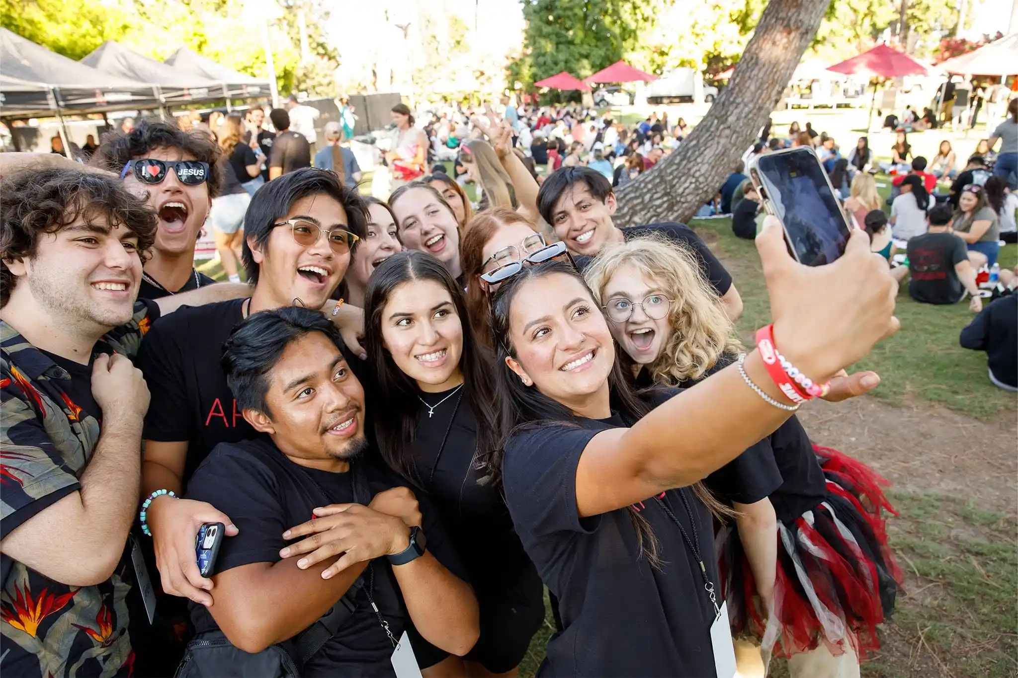 students wearing black apu t-shirt smiling for selfie