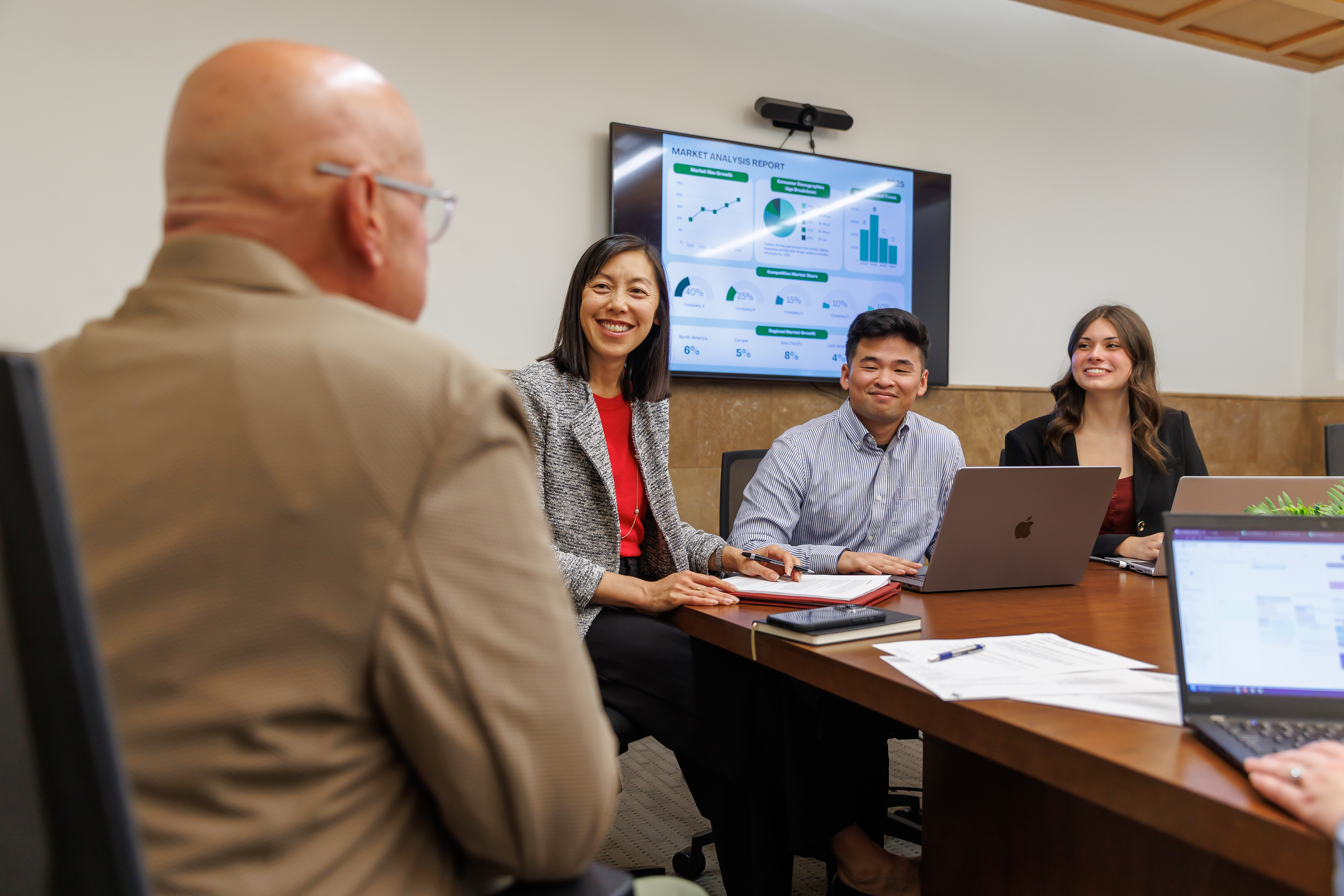 Business professors and students discussing a project.
