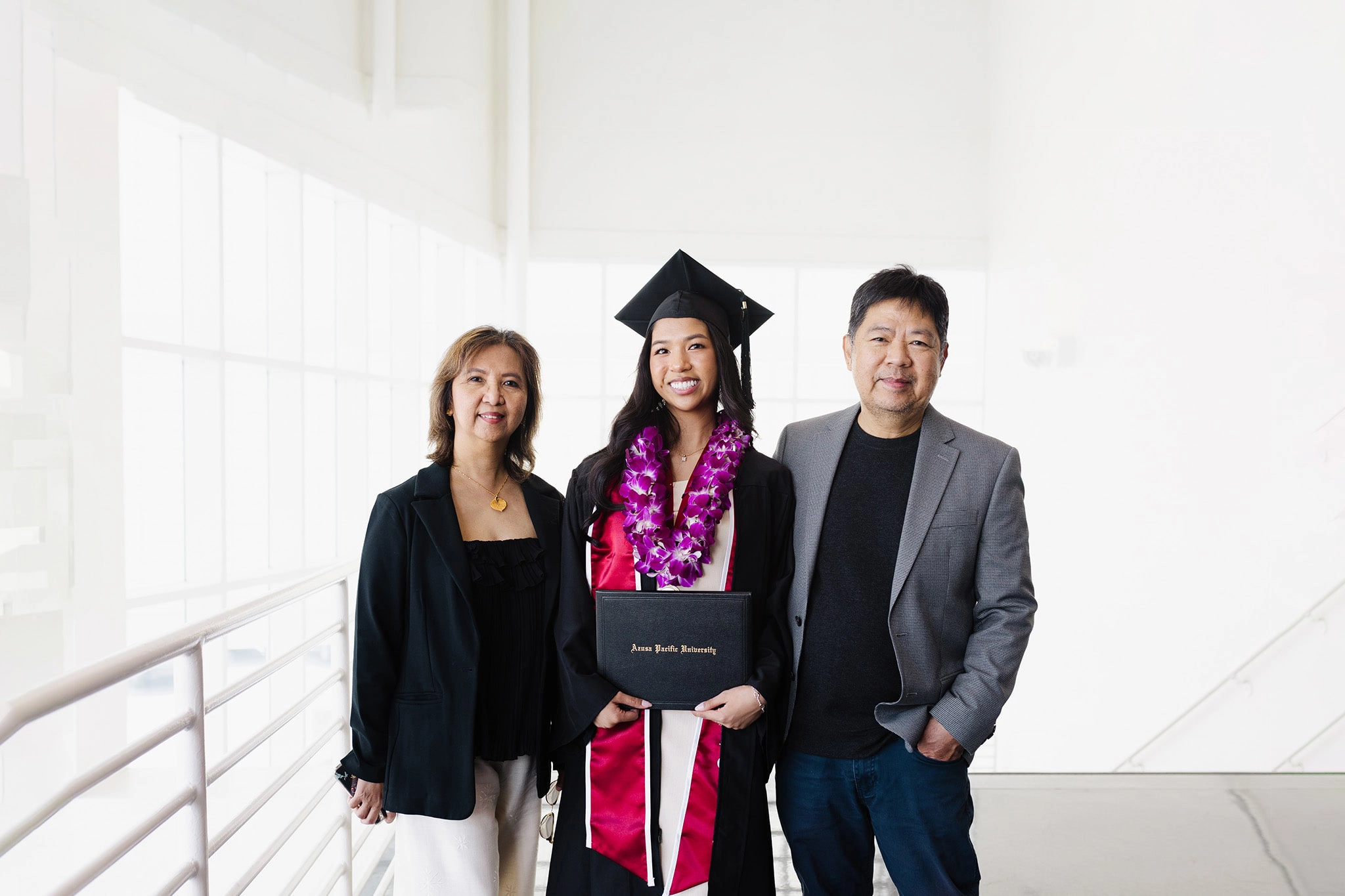 Asian-American female student between here two parents