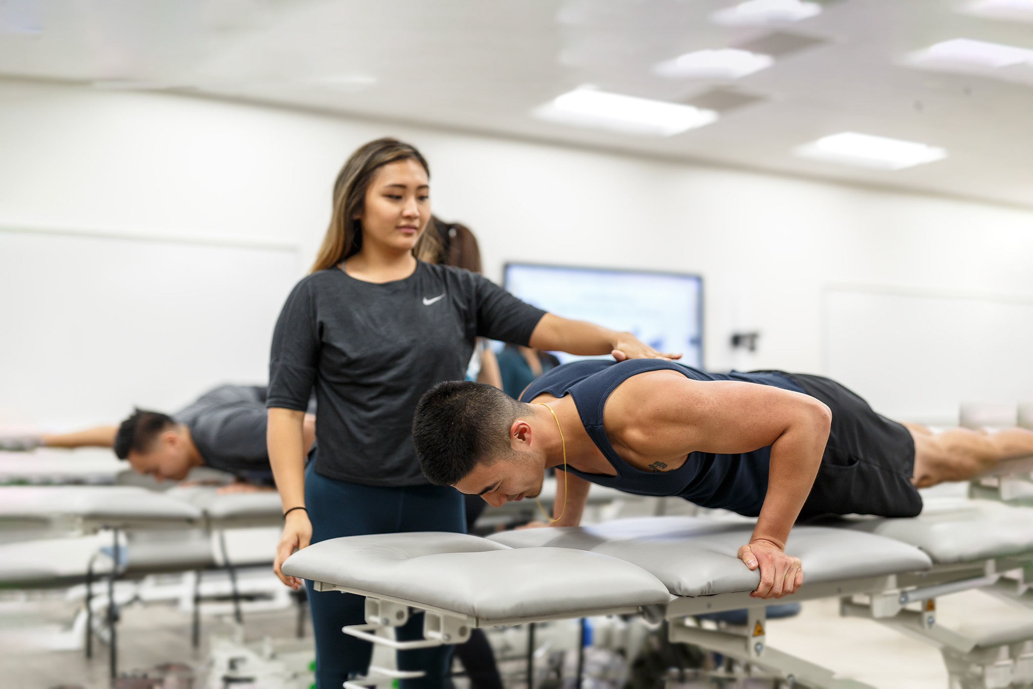 Student and instructor demonstrating physical therapy methods