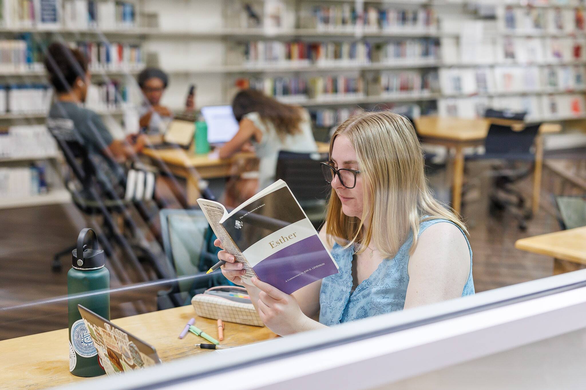 Student reading a book at the library