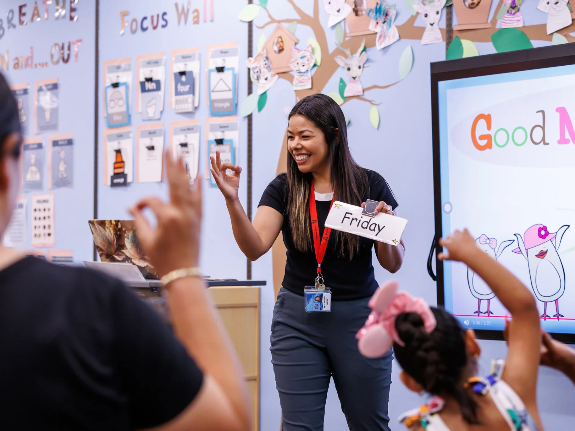 A teacher teaches elementary students in a classroom.