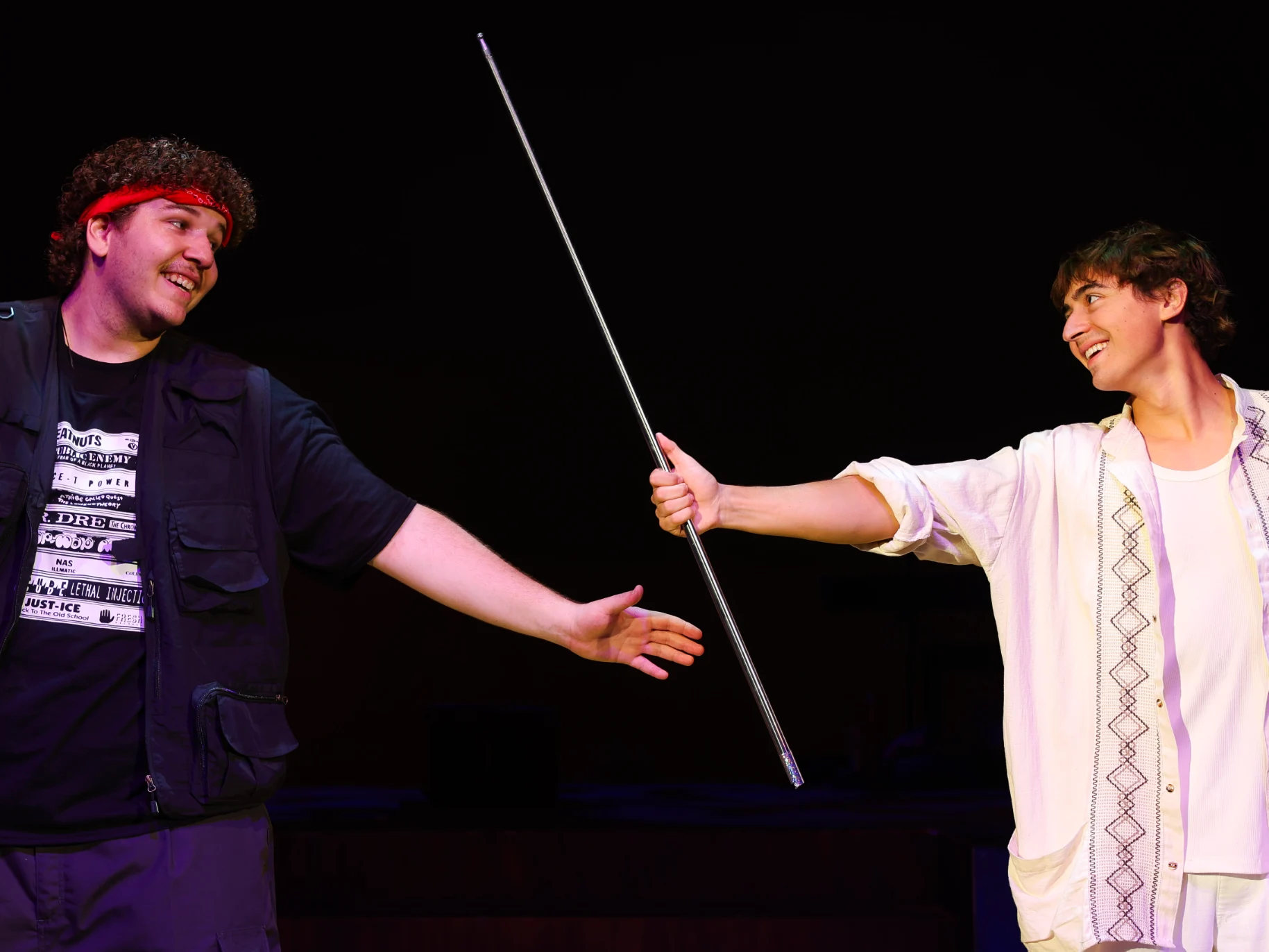 Two actors perform on stage.