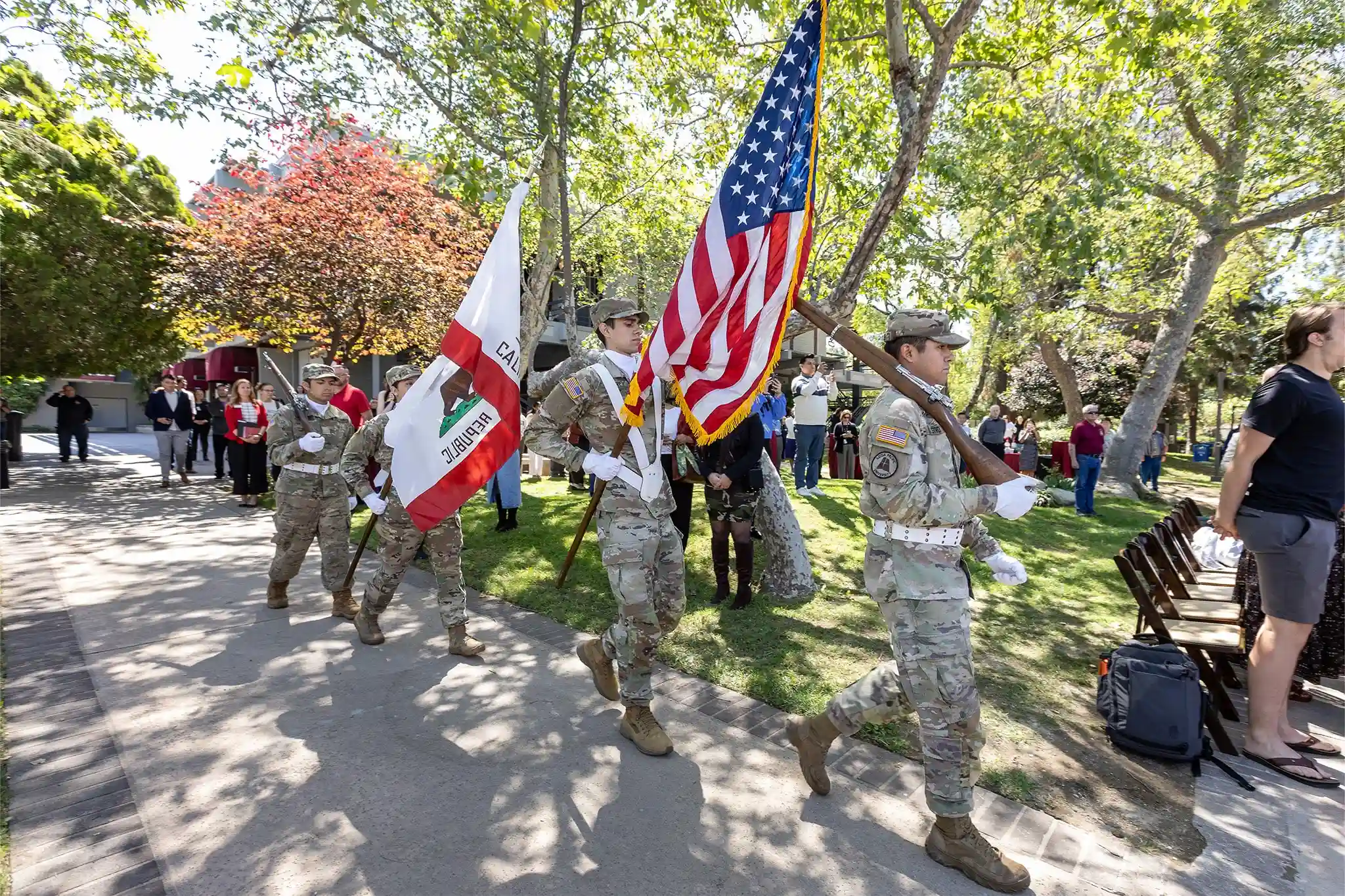 ROTC students marching with flags