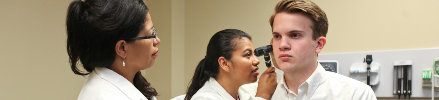 Nursing students checking on patient