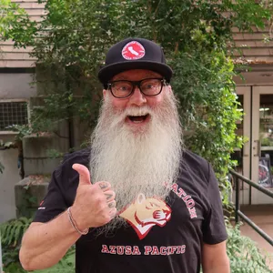 Matthew smiling and holding a thumbs up