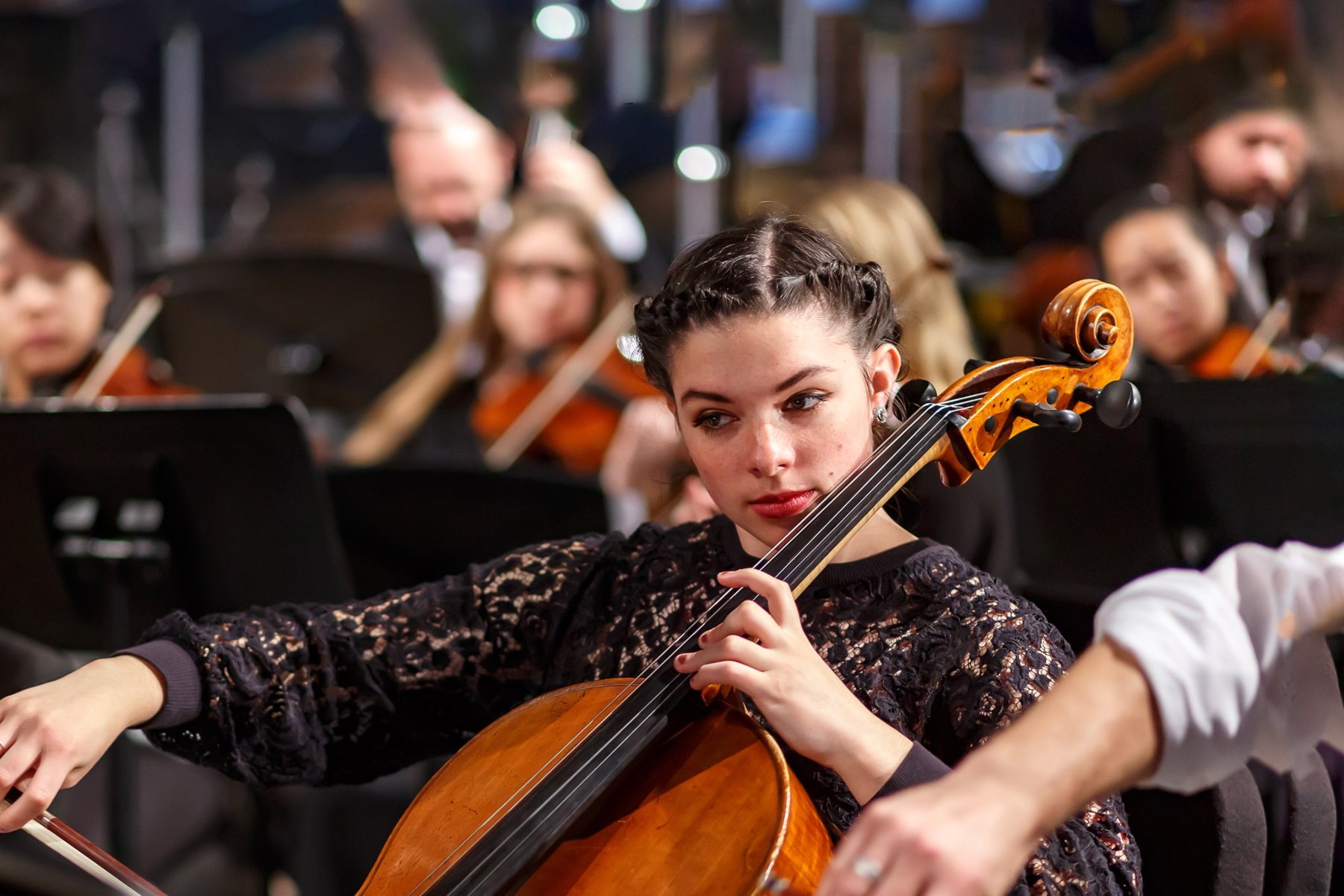 students playing the cello instrument wearing black dress