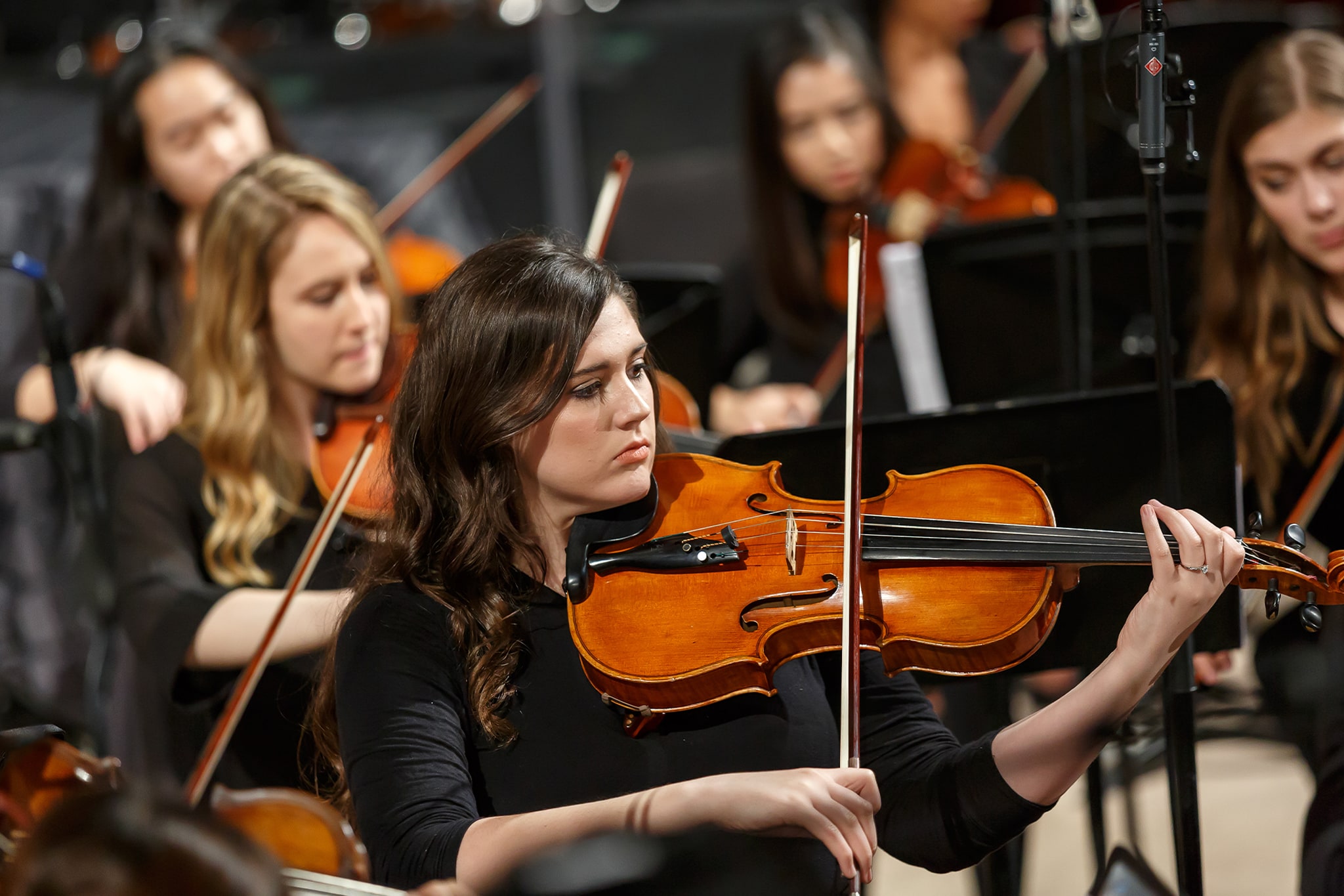 students playing the violin during orchestra