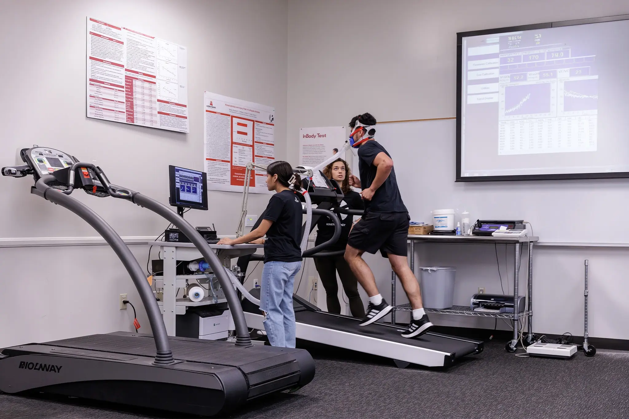 students running on a treadmill in class