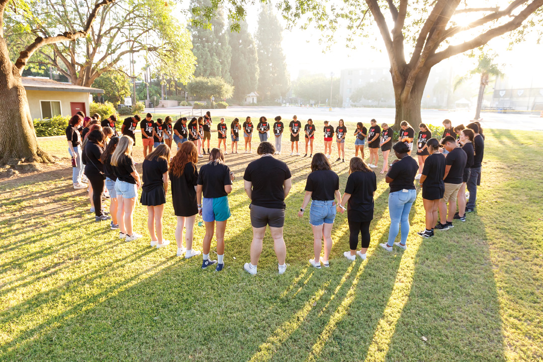 Students praying in a circle