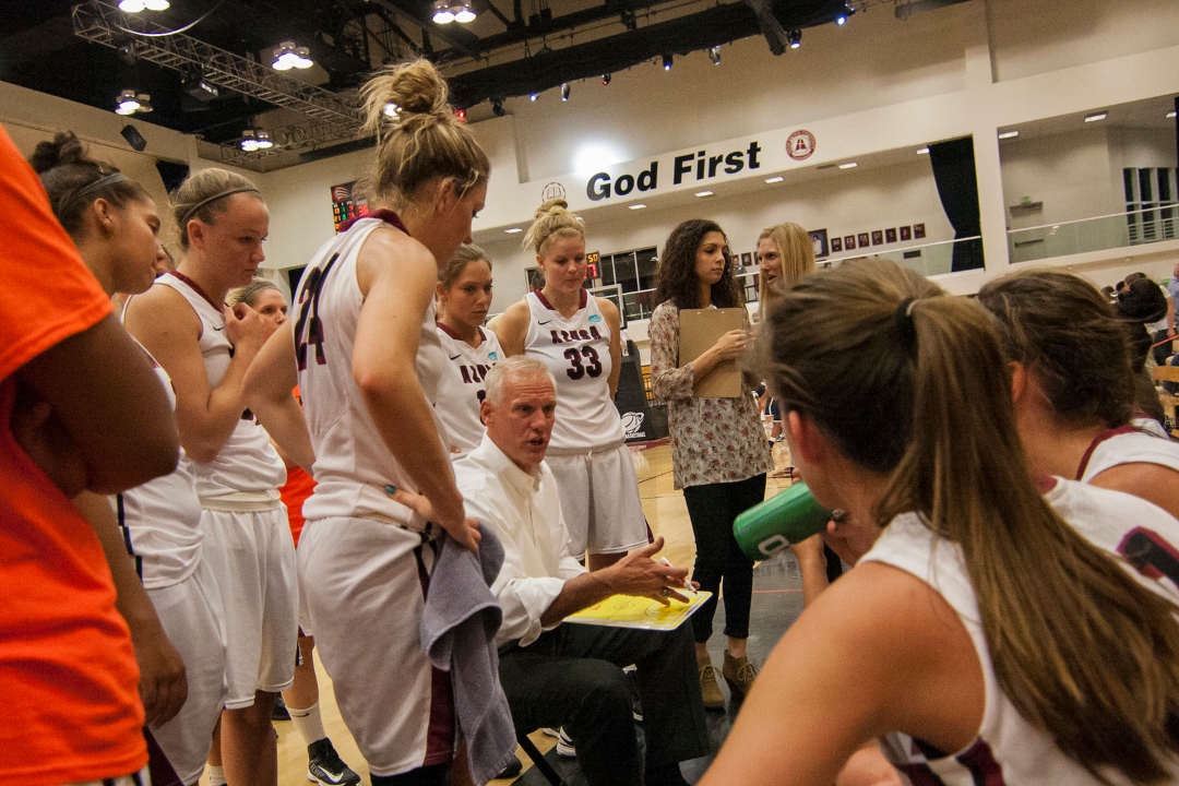 Basketball coach in team huddle