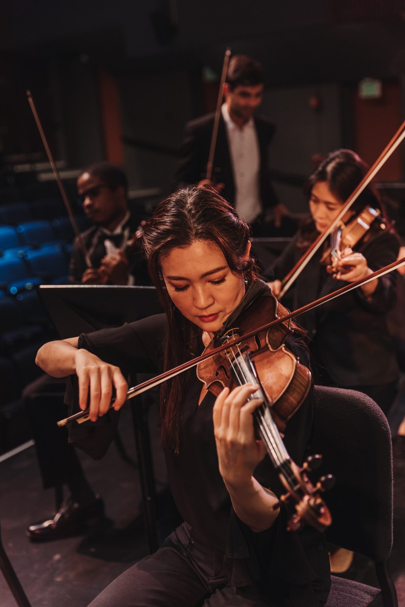 student playing the violin at the orchestra