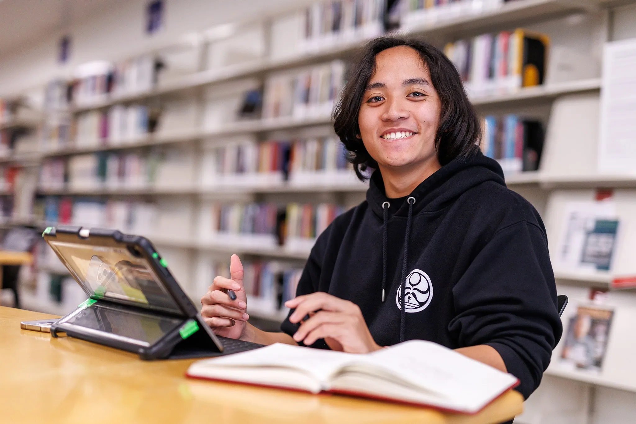 student smiling at the library