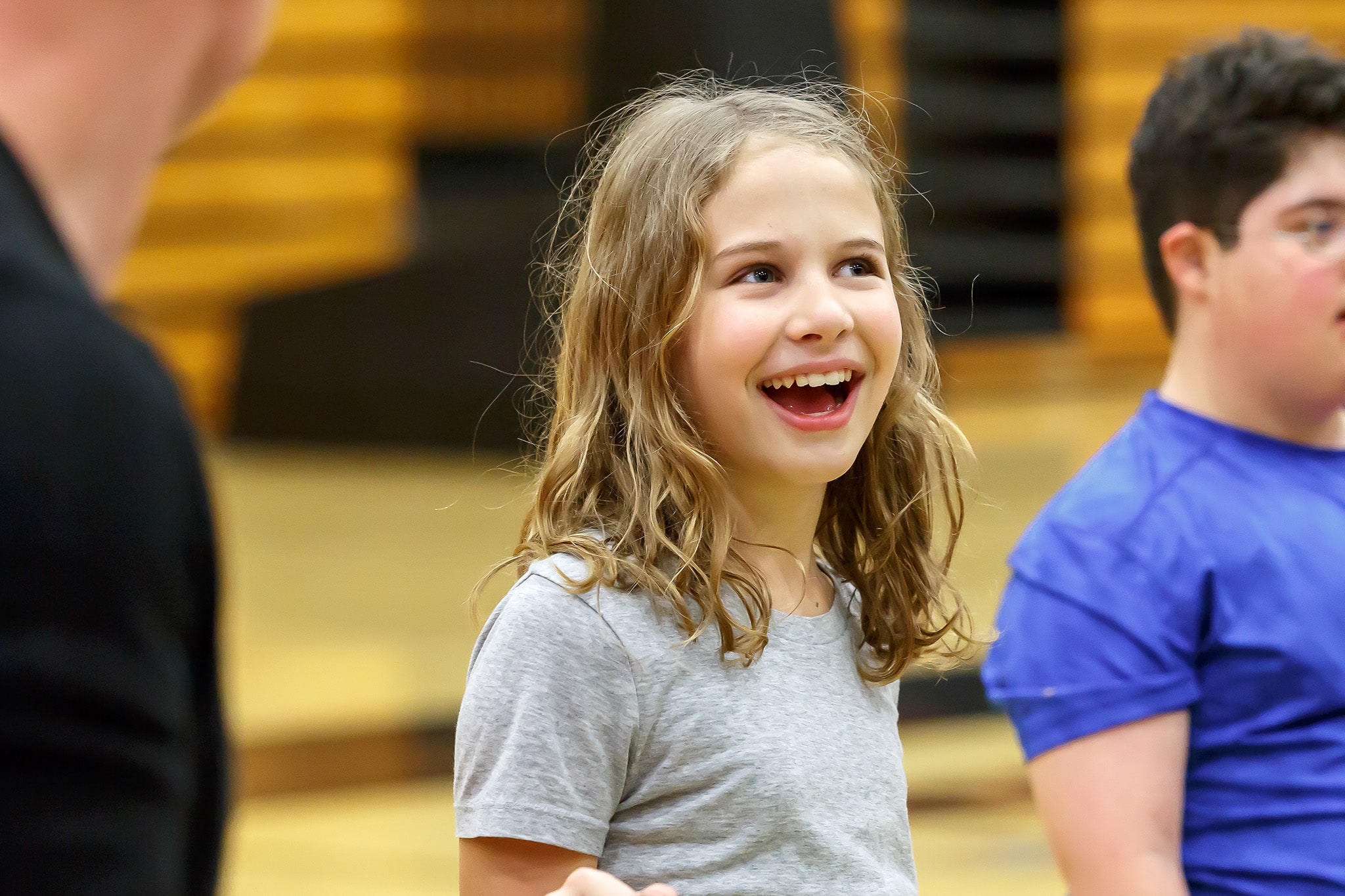 a child smilig during class activity