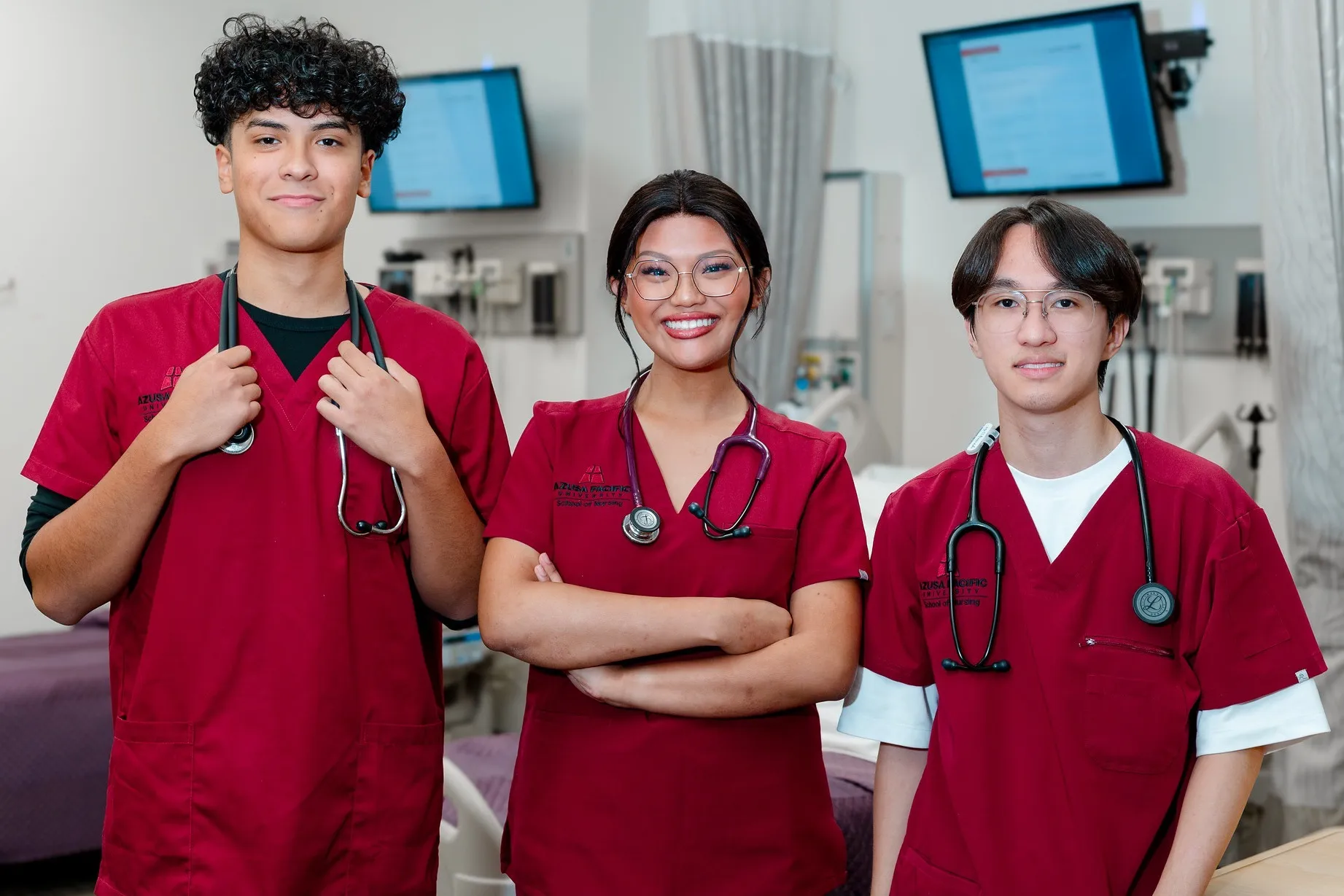 nursing students smiling at the picture with their uniforms